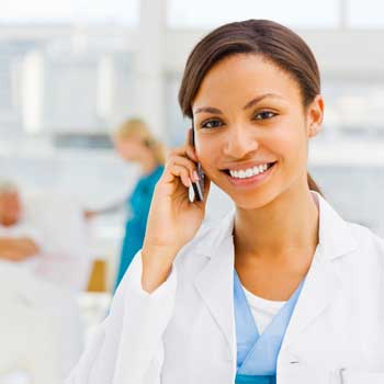 a doctor on a cell phone smiling